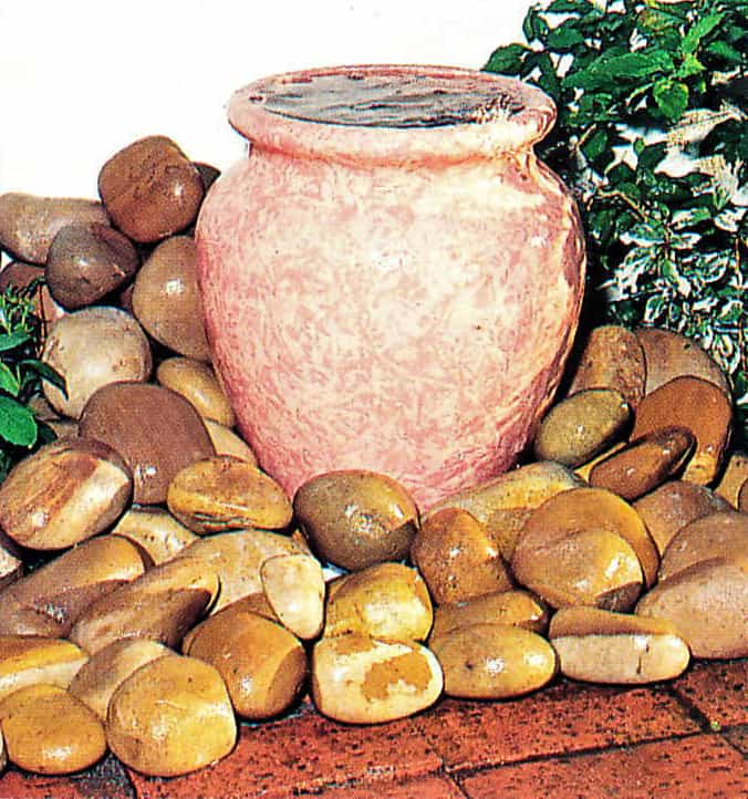 flowing clay pot with water trickling over the edge